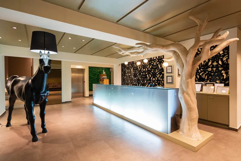 The lobby, with the horse lamp beside the lit reception desk